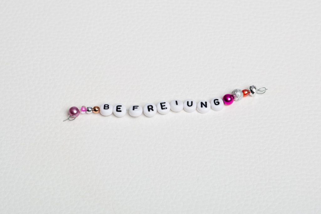 Perlenkette mit dem Wort Befreiung